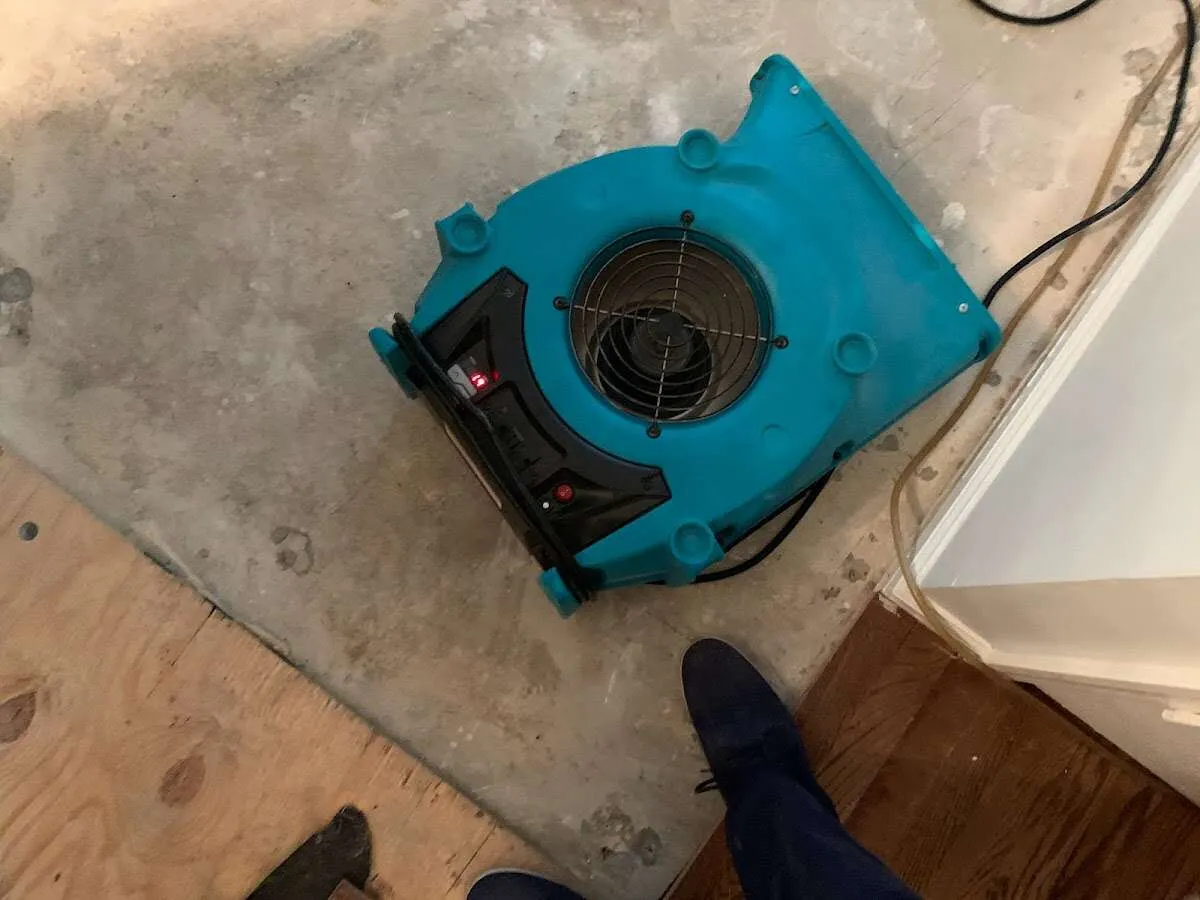 Air mover drying subfloor during Leak Detection & Repair in West Pensacola